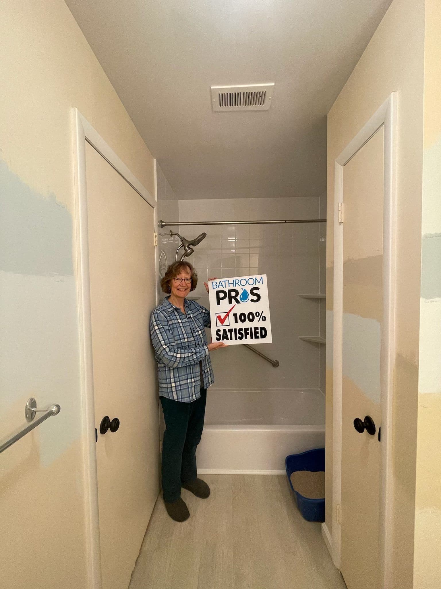 customer-holding-100-satisfied-sign-bathroom-pros